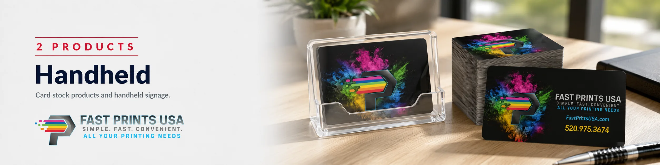 Business cards and a square handheld card printed with a rainbow Fast Prints USA logo, displayed in an acrylic card holder on a desk.